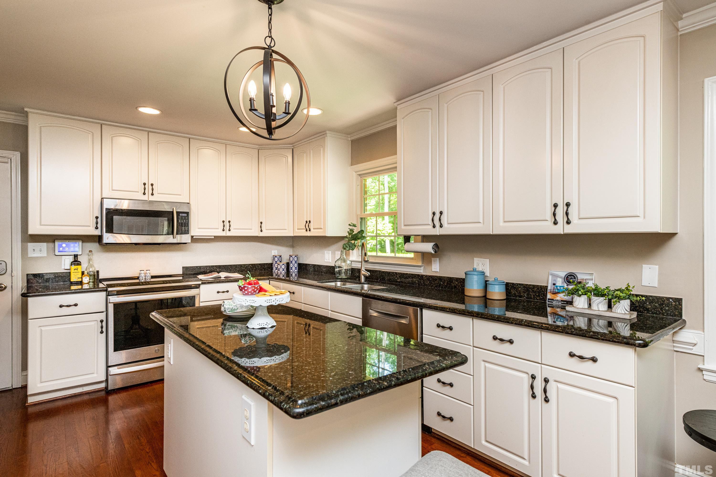 201 Chatterson Drive Raleigh, NC 27615 - Photo 5 of 44 a kitchen with stainless steel appliances granite countertop a sink a stove and a microwave