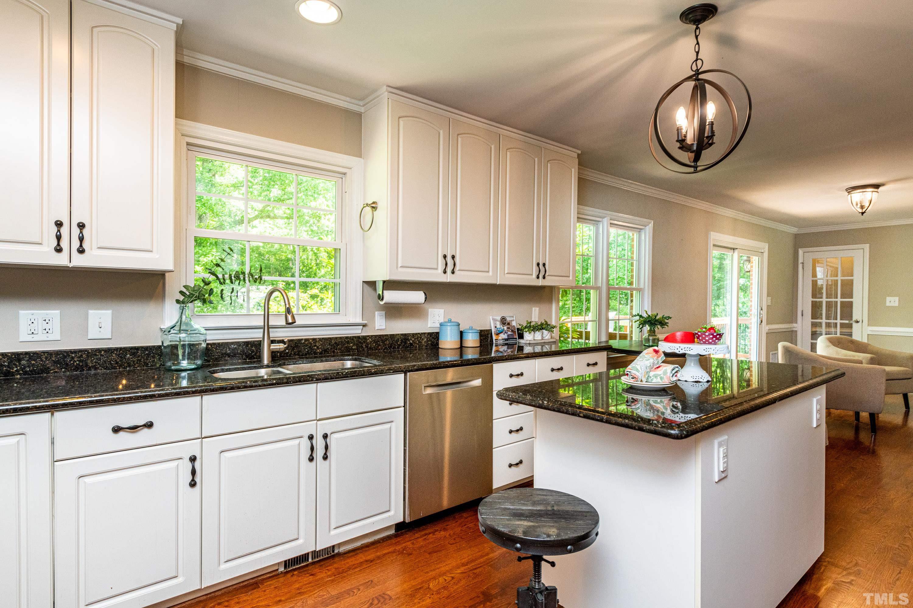 201 Chatterson Drive Raleigh, NC 27615 - Photo 6 of 44 a kitchen with stainless steel appliances granite countertop a stove a sink and a microwave