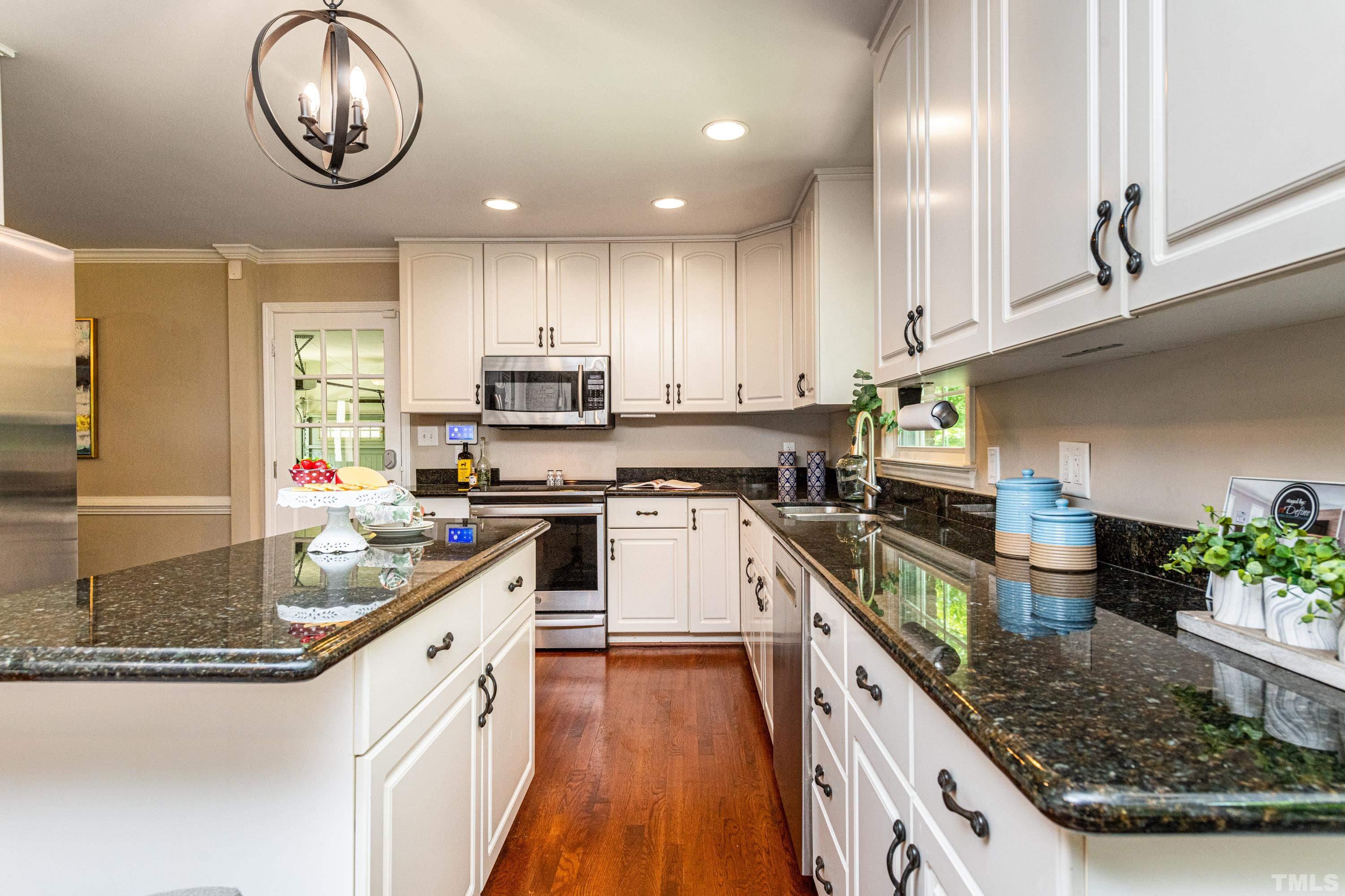 201 Chatterson Drive Raleigh, NC 27615 - Photo 7 of 44 a kitchen with stainless steel appliances granite countertop a sink a stove and cabinets