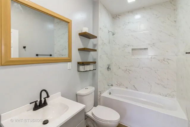 a bathroom with a toilet sink and bathtub