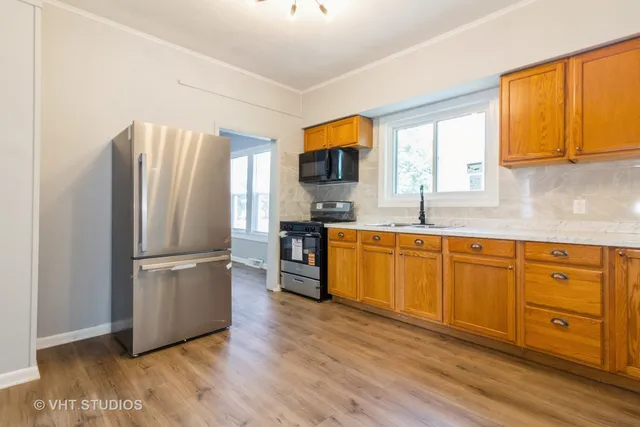 a kitchen with stainless steel appliances granite countertop a refrigerator sink and microwave