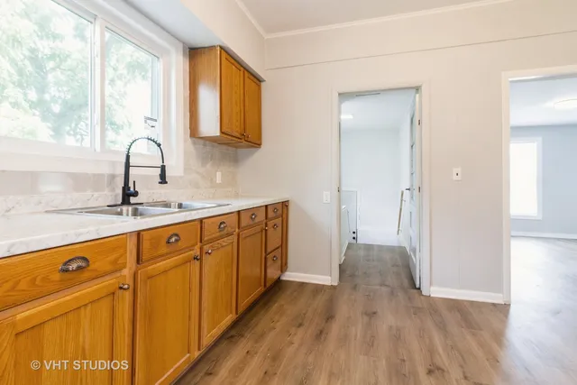 a kitchen with cabinets a sink and appliances