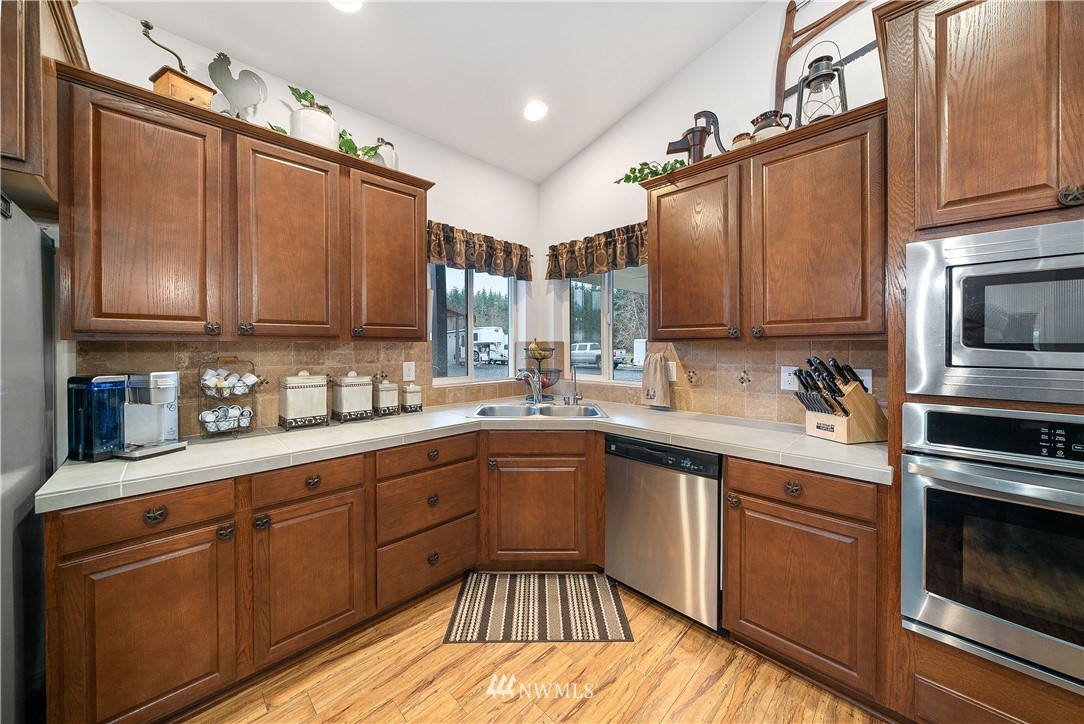 316 Pleasant Hill Road Chehalis, WA 98532 - Photo 10 of 30 a kitchen with stainless steel appliances granite countertop a sink a stove microwave and cabinets