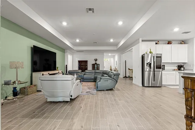 a kitchen with stainless steel appliances granite countertop a stove refrigerator and a fireplace