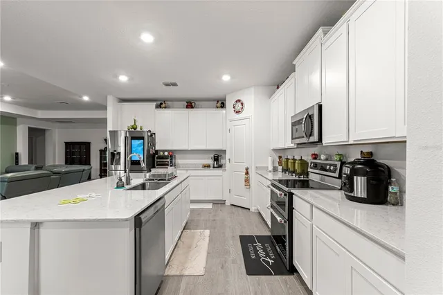 a kitchen that has a lot of cabinets and a refrigerator