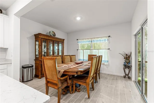a view of a dining room with furniture and a kitchen
