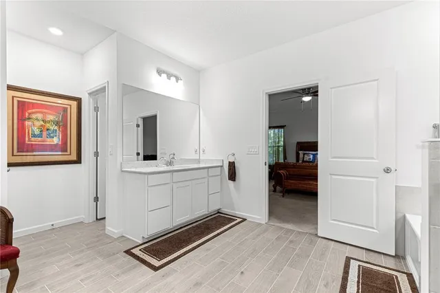 a room with a table chairs and refrigerator