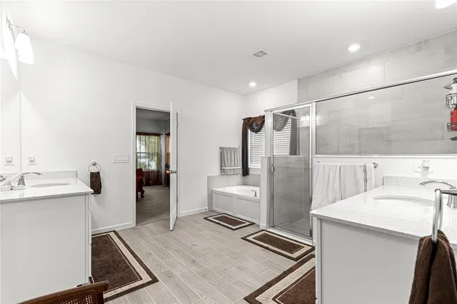 a bathroom with a granite countertop sink a toilet and shower