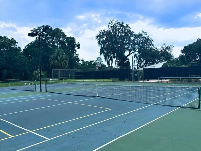 a front view of a house with a yard and potted plants