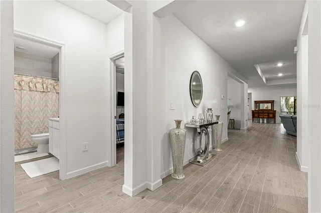 a living room with furniture a chandelier and a window