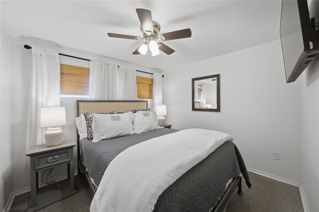126 Maples Trail Mabank, TX 75156 - Photo 16 of 23 a bedroom with a bed and a chandelier