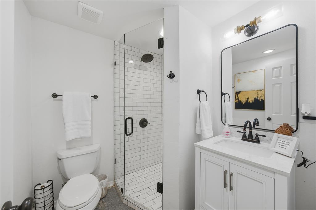 126 Maples Trail Mabank, TX 75156 - Photo 18 of 23 a bathroom with a toilet sink vanity and shower