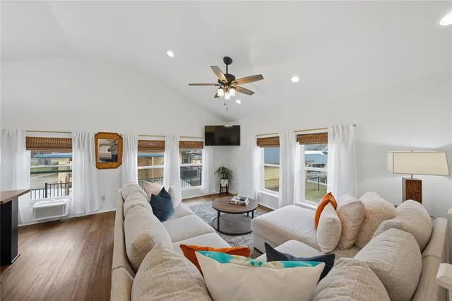 a living room with furniture ceiling fan and a wooden floor