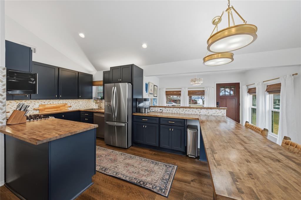 126 Maples Trail Mabank, TX 75156 - Photo 6 of 21 a kitchen with stainless steel appliances granite countertop a sink stove and refrigerator
