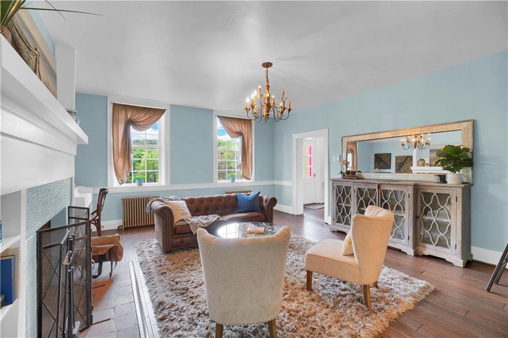 2560 Chapel Road Beaver, PA 15009 - Photo 7 of 25 a living room with furniture a fireplace and a chandelier