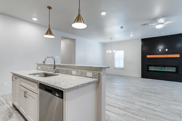 a kitchen with a sink and a refrigerator