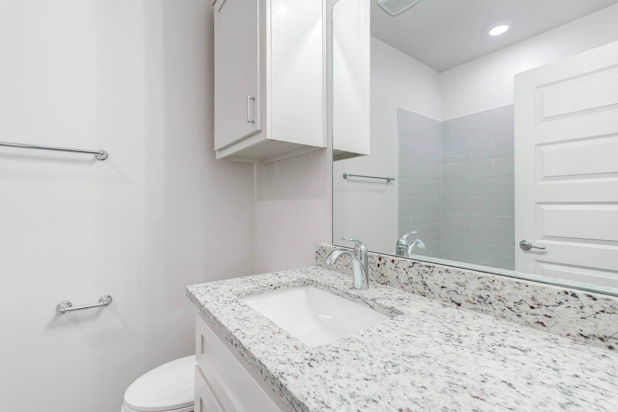 7040 41st Street Lubbock, TX 79407 - Photo 19 of 22 a bathroom with a granite countertop sink and a toilet