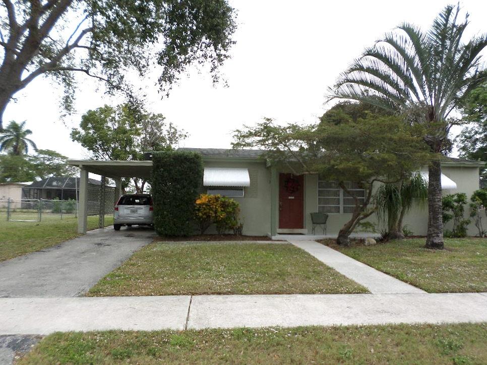 344 Mid Pines Road Palm Springs, FL 33461 - Photo 2 of 20 a front view of a house with a yard