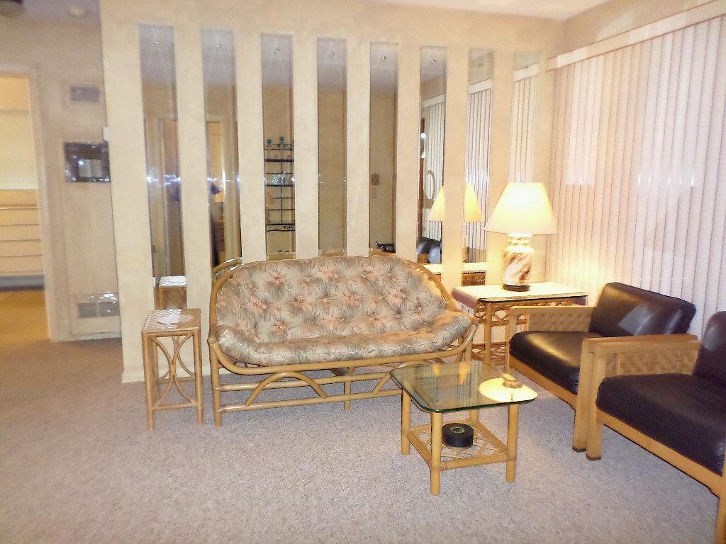344 Mid Pines Road Palm Springs, FL 33461 - Photo 4 of 20 a living room with furniture and a large window