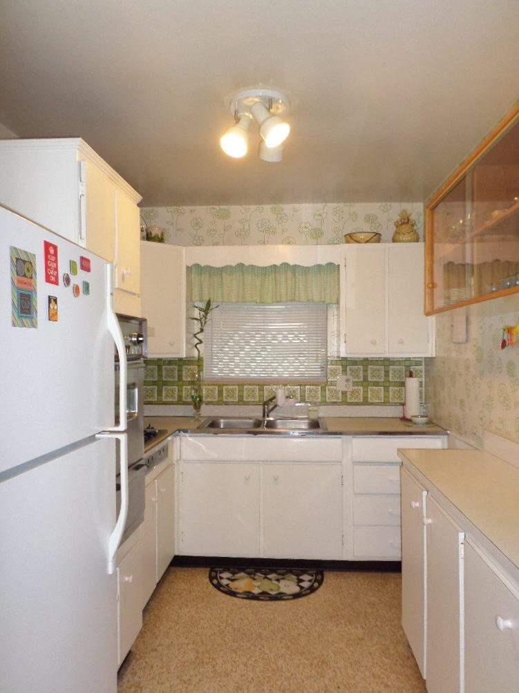 344 Mid Pines Road Palm Springs, FL 33461 - Photo 8 of 20 a kitchen with a sink a refrigerator and cabinets
