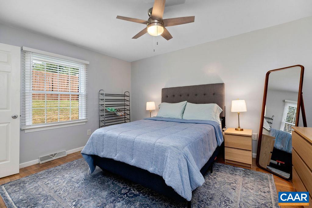 114 Hessian Hills Ridge, Unit 1 Charlottesville, VA 22901 - Photo 11 of 20 a bedroom with a bed a chandelier and a television