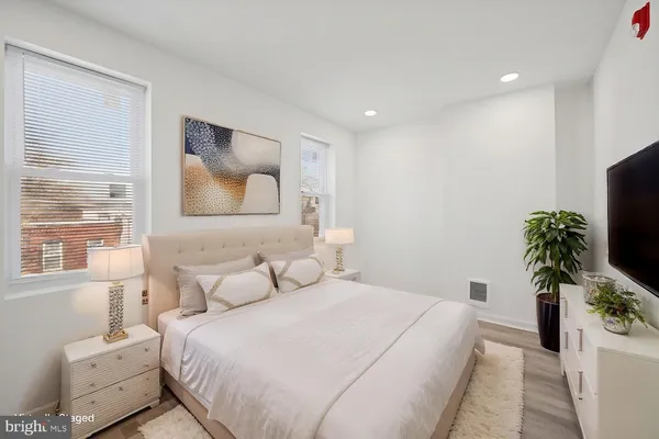 a bedroom with a bed and a flat screen tv