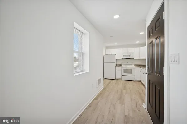 a view of kitchen with wooden floor