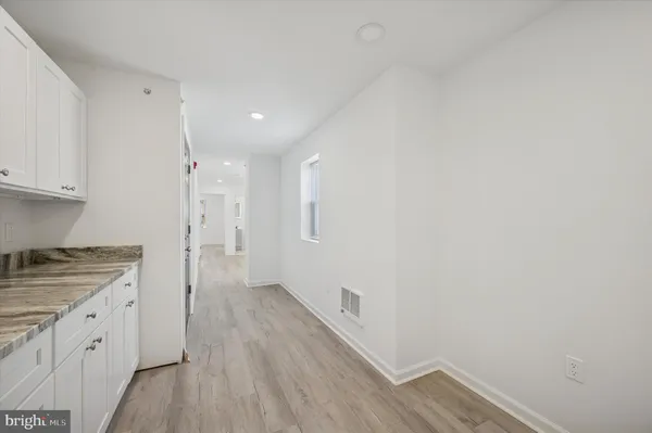 a view of a kitchen with wooden floor