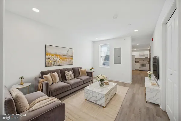 a living room with furniture and a wooden floor