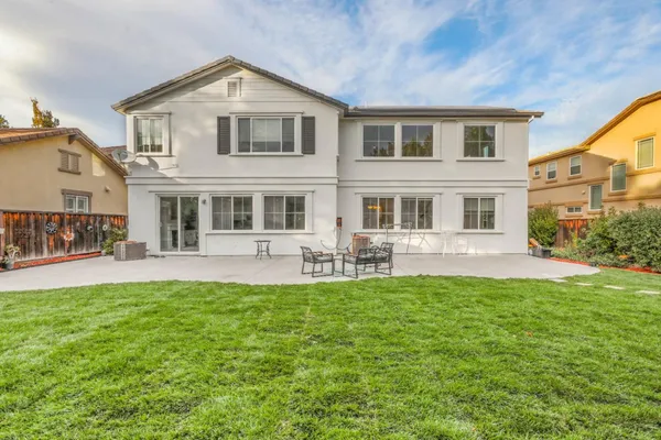 a view of a house with a yard patio and swimming pool