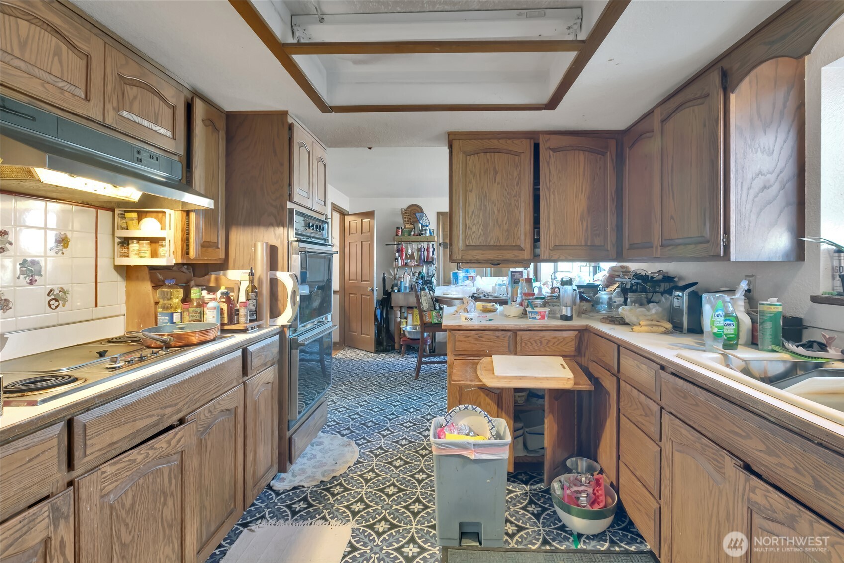 26836 Southeast 208th Street Maple Valley, WA 98038 - Photo 24 of 37 a kitchen with a sink and wooden cabinets