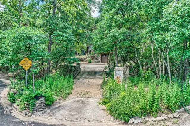 a view of a garden with lawn chairs and plants