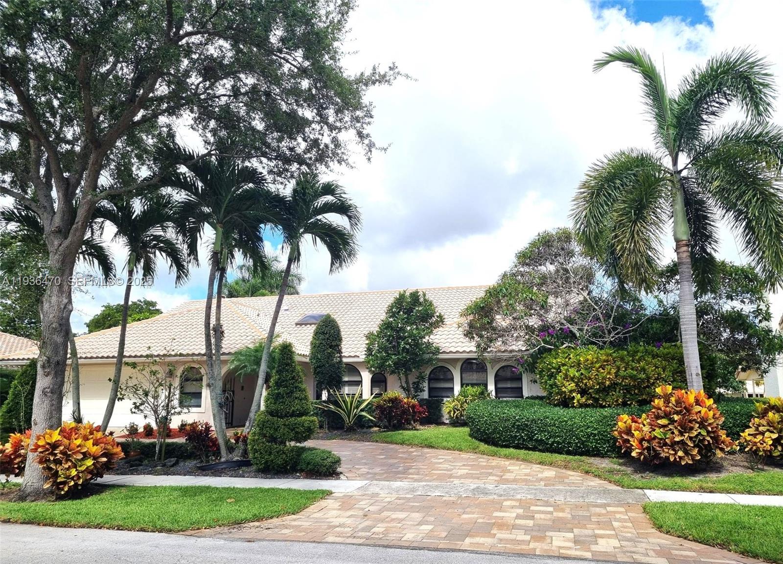 2685 Northwest 27th Terrace Boca Raton, FL 33434 - Photo 1 of 31 a front view of a house with garden
