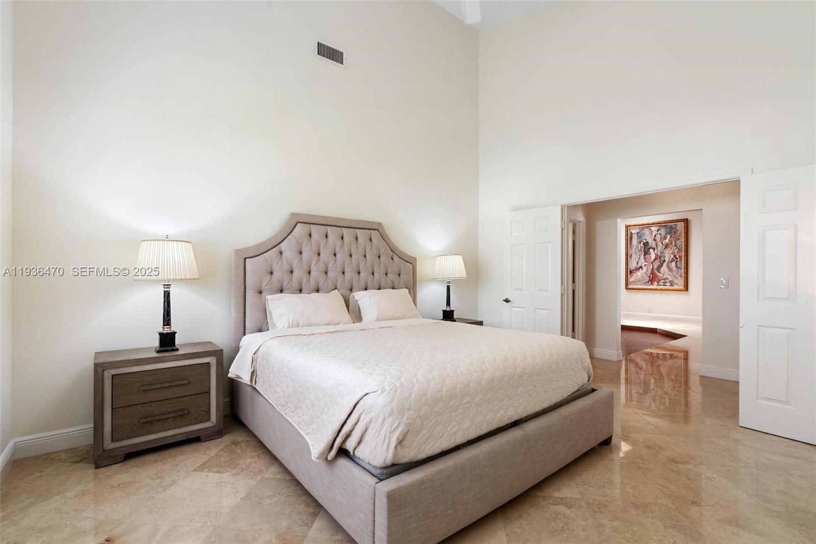 2685 Northwest 27th Terrace Boca Raton, FL 33434 - Photo 18 of 31 a bedroom with a bed and a lamp on table