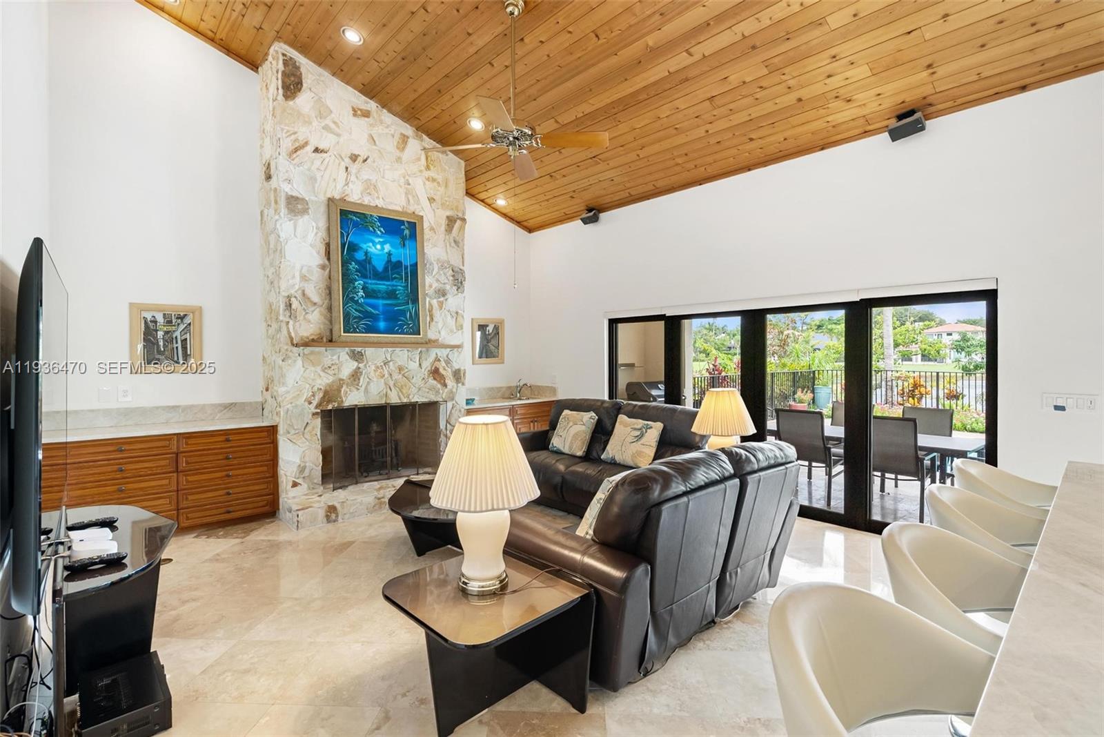 2685 Northwest 27th Terrace Boca Raton, FL 33434 - Photo 20 of 31 a living room with furniture a fireplace and a table