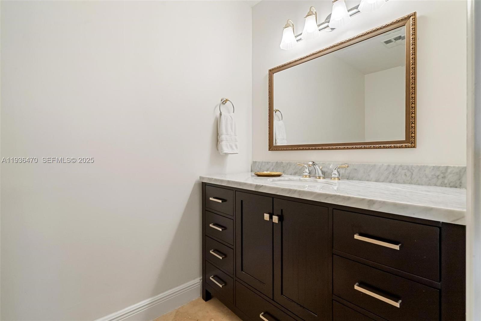 2685 Northwest 27th Terrace Boca Raton, FL 33434 - Photo 22 of 31 a bathroom with a sink vanity and mirror
