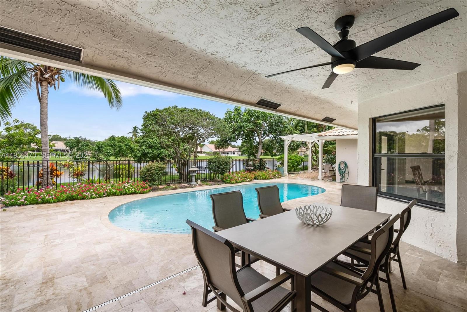 2685 Northwest 27th Terrace Boca Raton, FL 33434 - Photo 23 of 31 a view of a patio with a table chairs and a table