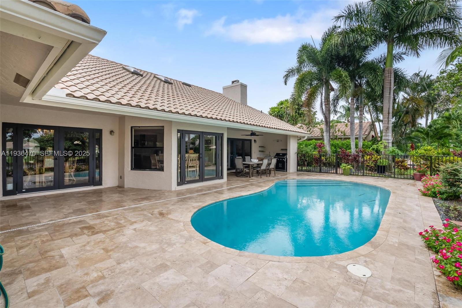2685 Northwest 27th Terrace Boca Raton, FL 33434 - Photo 26 of 31 a view of a house with swimming pool and porch
