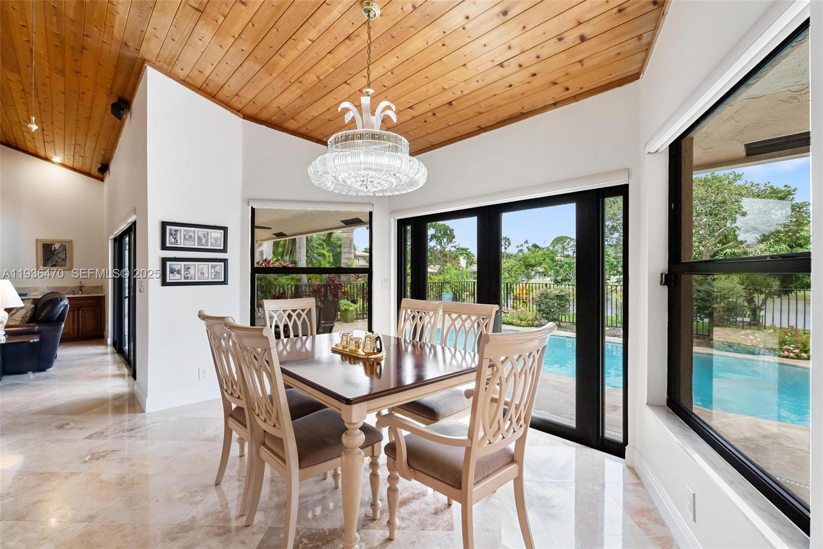 2685 Northwest 27th Terrace Boca Raton, FL 33434 - Photo 6 of 31 a view of a dining room with furniture large window and chandelier