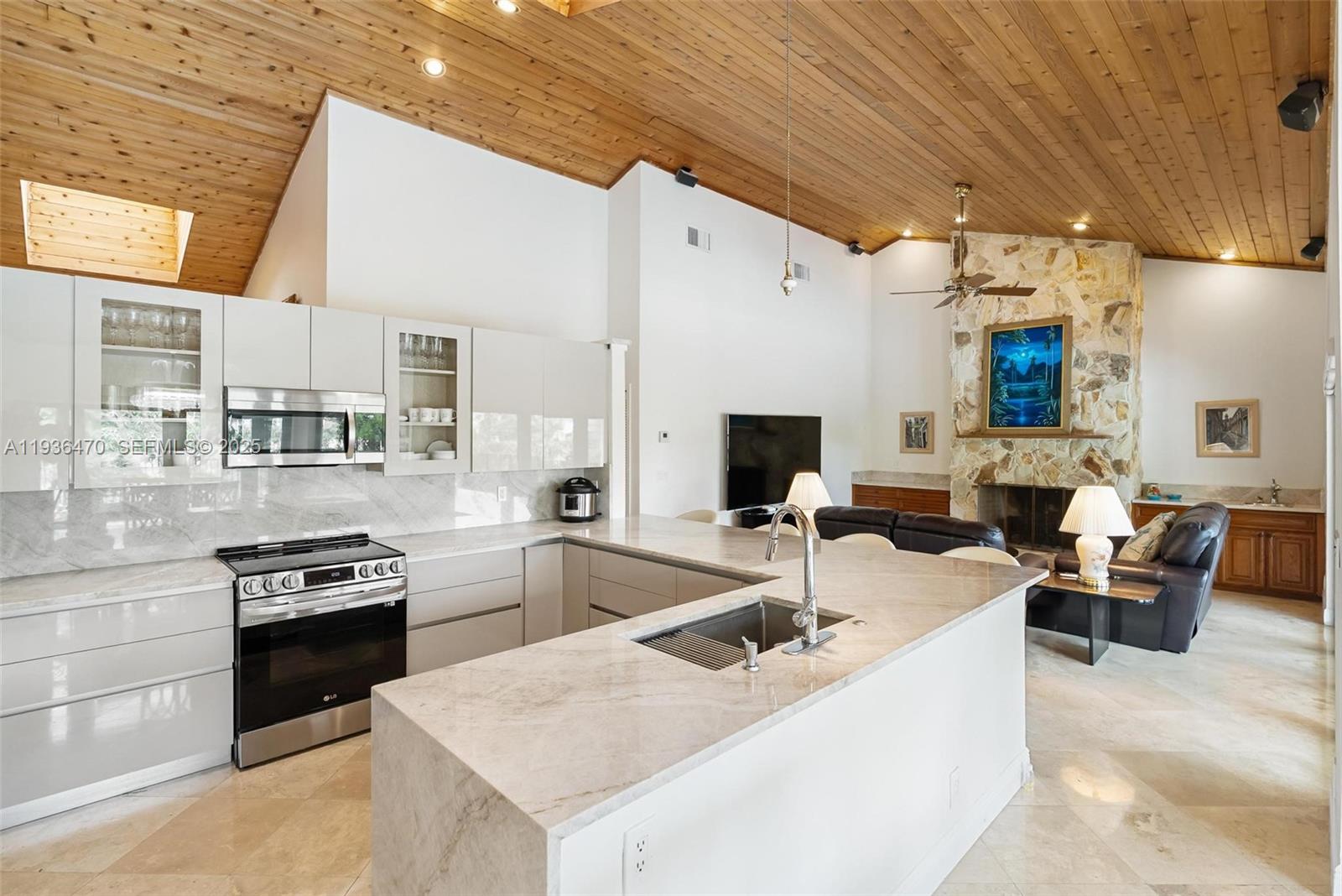 2685 Northwest 27th Terrace Boca Raton, FL 33434 - Photo 7 of 31 a kitchen with stainless steel appliances granite countertop a sink a stove and a refrigerator