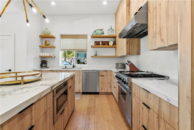 a kitchen with kitchen island a sink stove and cabinets