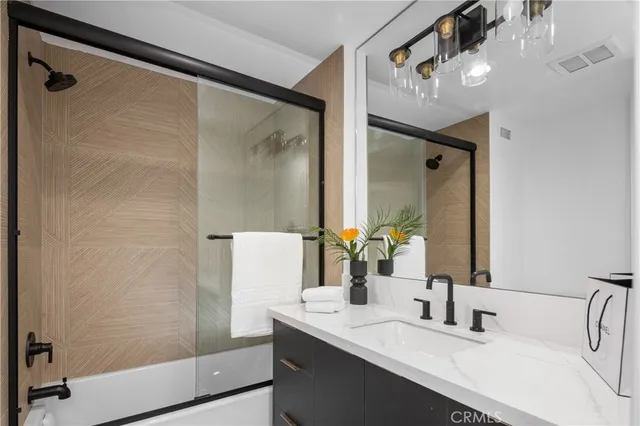 a bathroom with a double vanity sink a mirror and shower