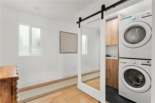 a spacious bedroom with a bed and a dresser