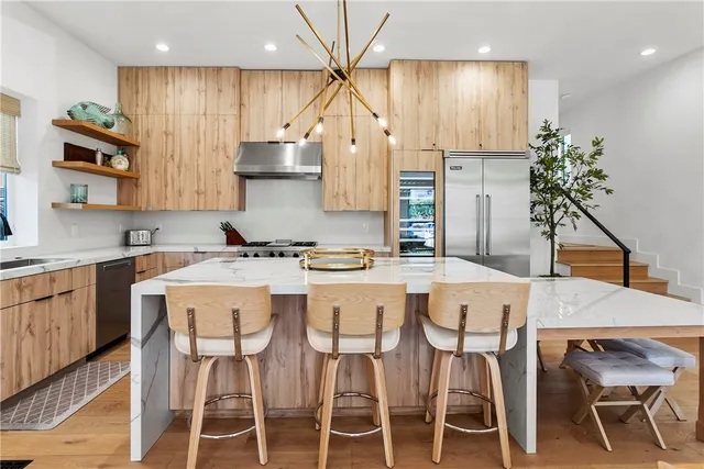 a living room with furniture a dining table and a large window