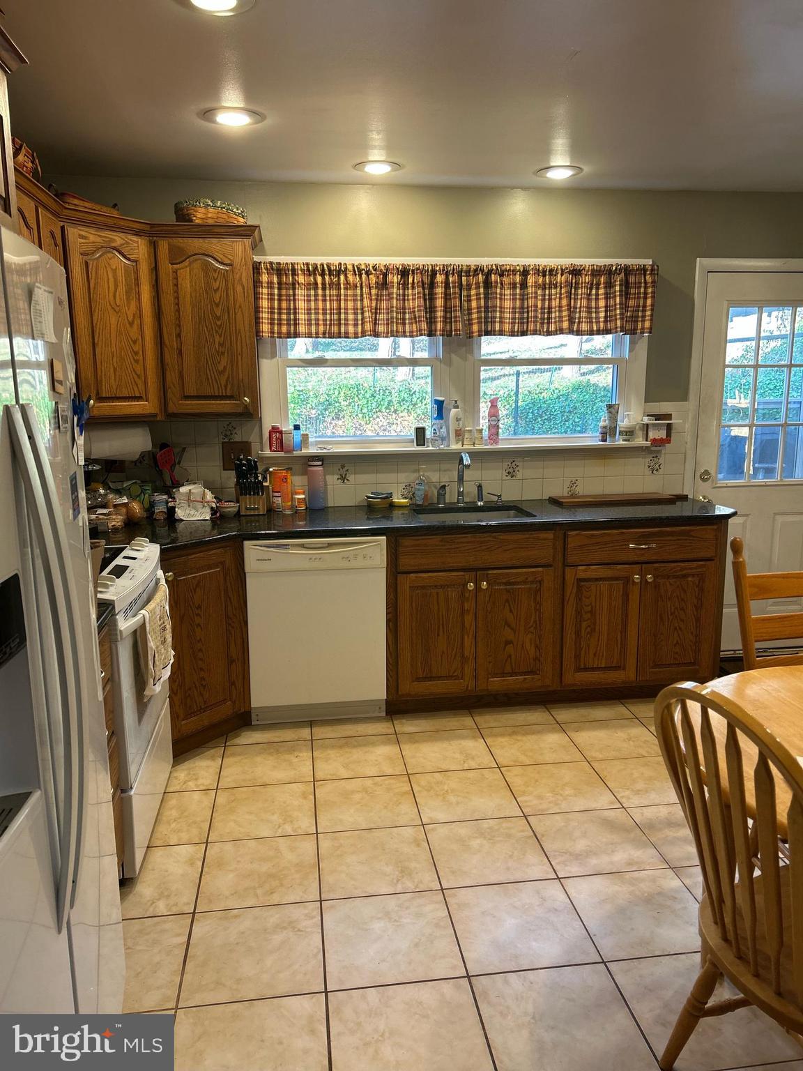 617 Meadowlark Road Norristown, PA 19403 - Photo 19 of 20 a kitchen with stainless steel appliances granite countertop a sink and cabinets
