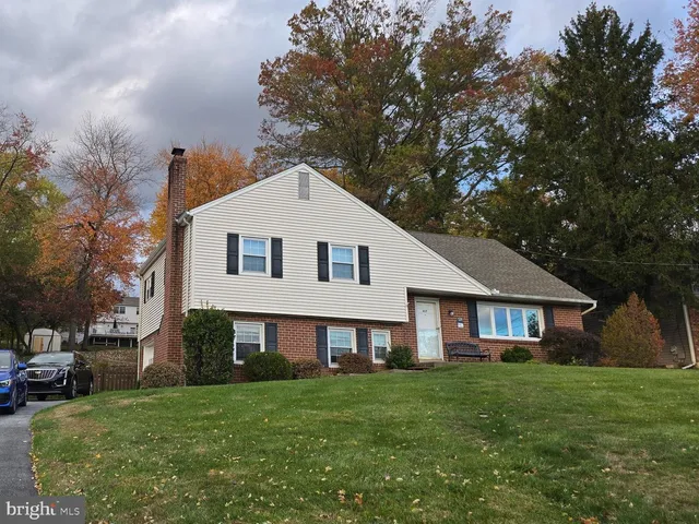 a front view of a house with a garden and porch