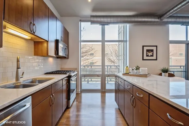 a kitchen with stainless steel appliances granite countertop a sink stove and cabinets