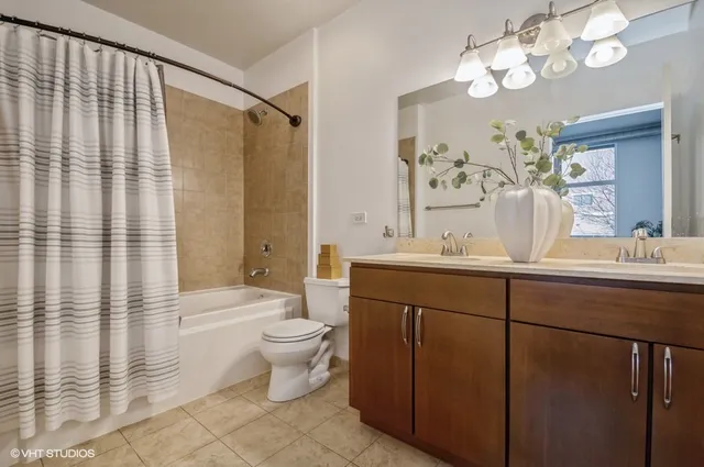a bathroom with a double vanity sink mirror and toilet