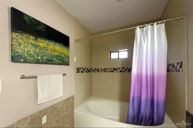 a bathroom with a bathtub and shower