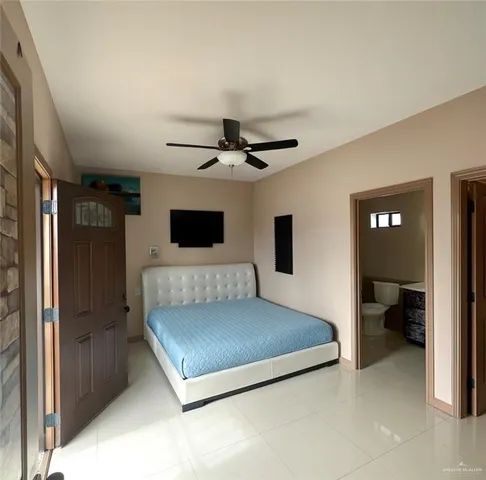 a living room with a bed furniture and a flat tv screen